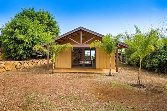 rear view of property with an outdoor structure