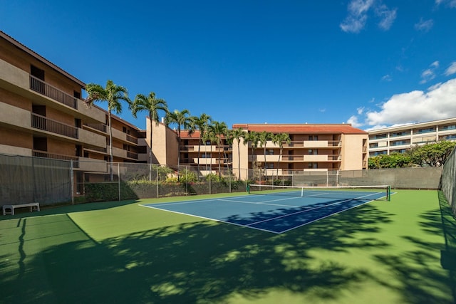 view of tennis court with basketball hoop