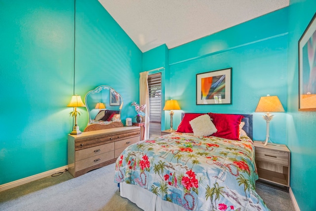 carpeted bedroom featuring a textured ceiling and vaulted ceiling