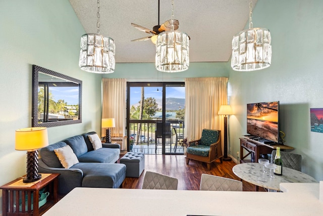 living room with ceiling fan, plenty of natural light, high vaulted ceiling, and dark hardwood / wood-style floors