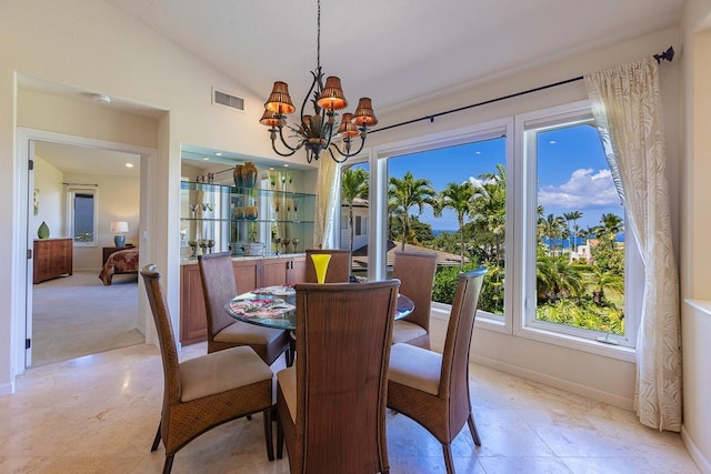 dining room with a chandelier, visible vents, baseboards, and vaulted ceiling