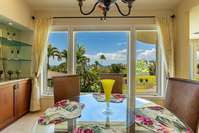 dining space featuring an inviting chandelier, a wealth of natural light, and visible vents