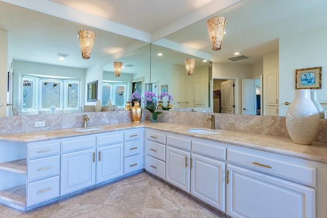 full bathroom with a sink, double vanity, and visible vents