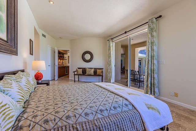 bedroom with baseboards, ensuite bathroom, visible vents, and access to exterior