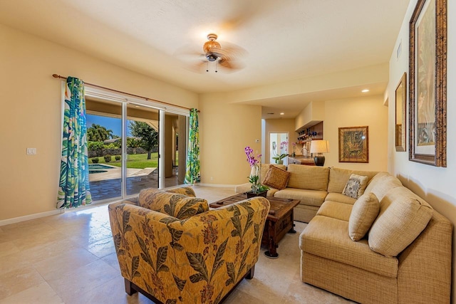 living room with baseboards, a ceiling fan, and recessed lighting