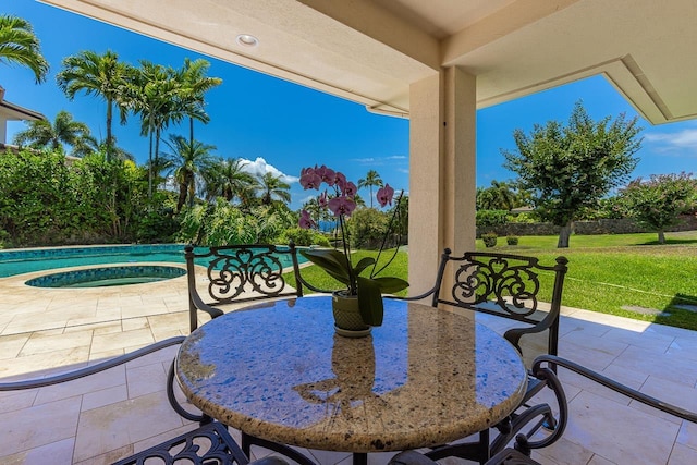 view of patio featuring an in ground hot tub and an outdoor pool