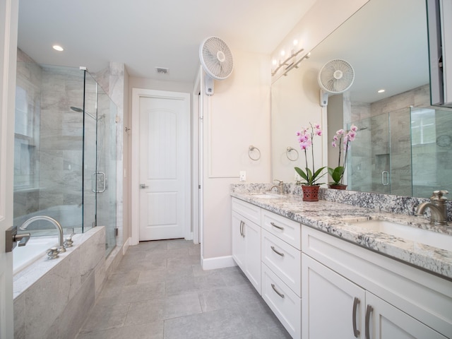 bathroom with vanity and independent shower and bath