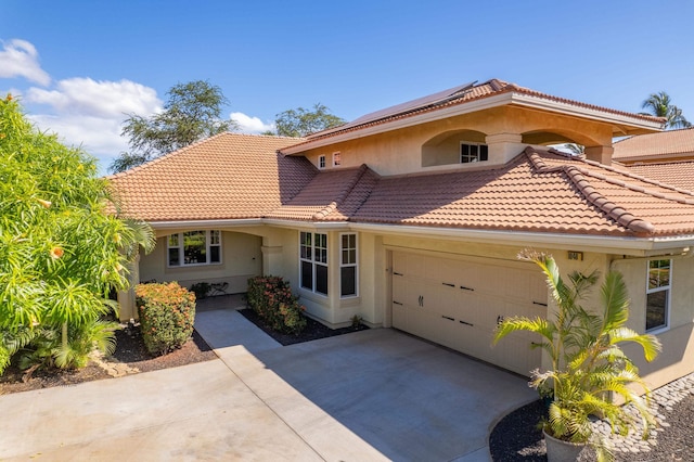 mediterranean / spanish house featuring a garage