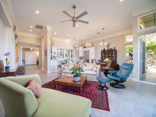 tiled living room with ceiling fan with notable chandelier and crown molding