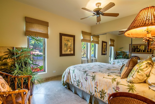 bedroom featuring light tile patterned floors, ceiling fan, and a closet