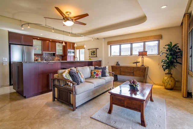 living room featuring rail lighting and ceiling fan