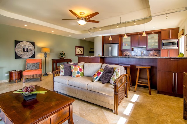 living room featuring sink and ceiling fan