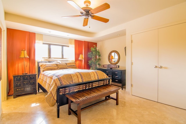 bedroom with ceiling fan, a closet, and light tile patterned floors