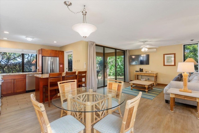 dining space with ceiling fan and light hardwood / wood-style floors