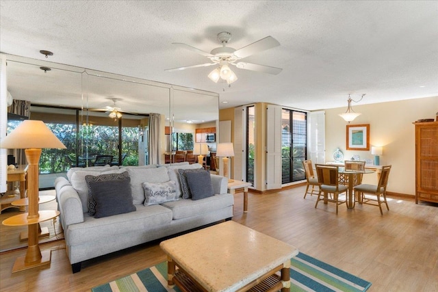 living room with hardwood / wood-style flooring, plenty of natural light, and a textured ceiling