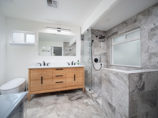 bathroom featuring toilet, tile flooring, tiled shower, and dual bowl vanity