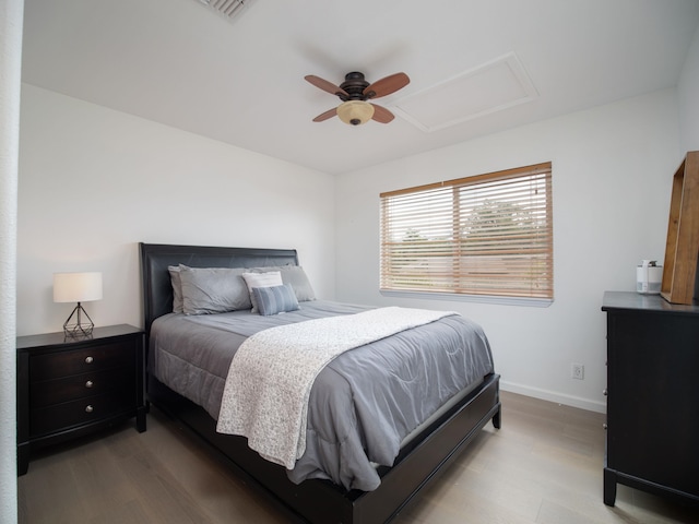 bedroom with ceiling fan and light hardwood / wood-style flooring