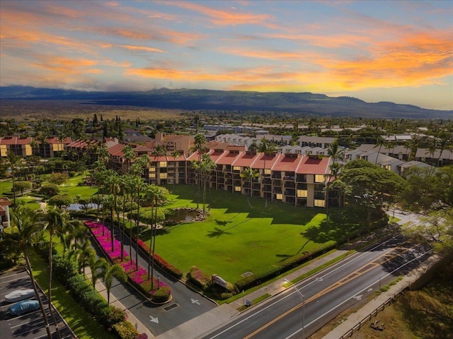 aerial view at dusk featuring a residential view and a mountain view