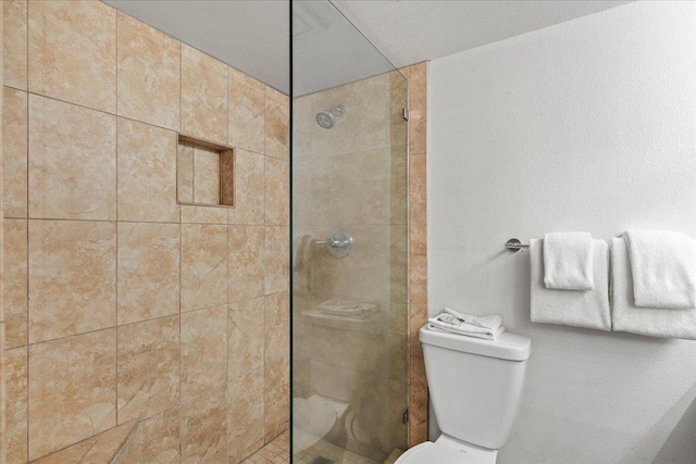 bathroom with a walk in shower and toilet