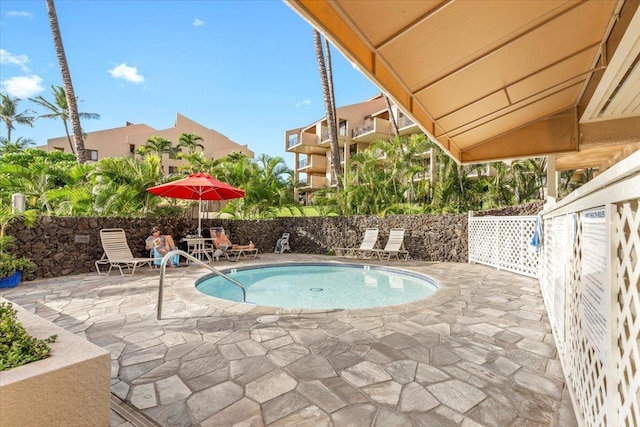 view of swimming pool with a swimming pool, a patio area, and fence
