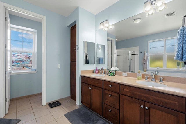 full bath featuring tile patterned flooring, a stall shower, visible vents, and a sink