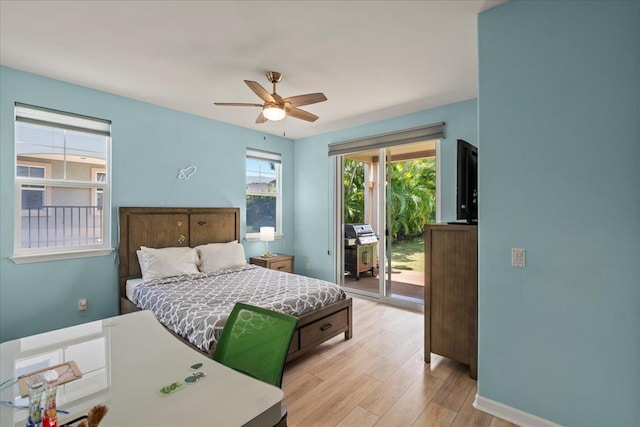 bedroom featuring light wood-style flooring, baseboards, a ceiling fan, and access to outside