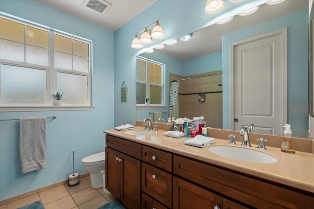 bathroom featuring tile patterned floors, toilet, visible vents, and a sink