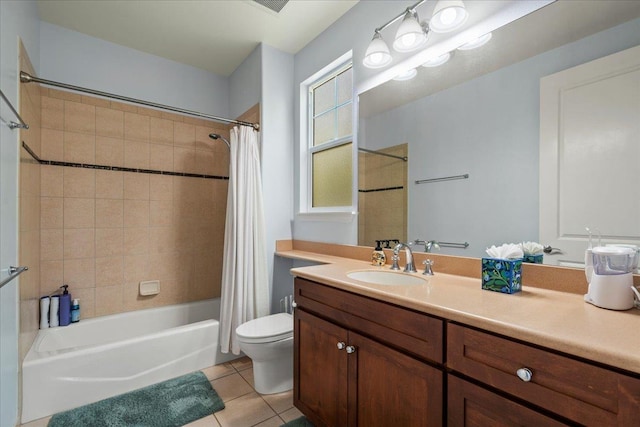 full bathroom featuring tile patterned floors, shower / tub combo with curtain, vanity, and toilet