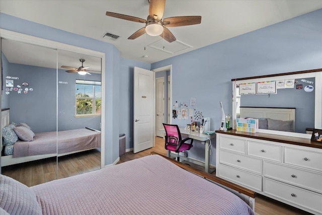 bedroom featuring visible vents, wood finished floors, a closet, baseboards, and ceiling fan