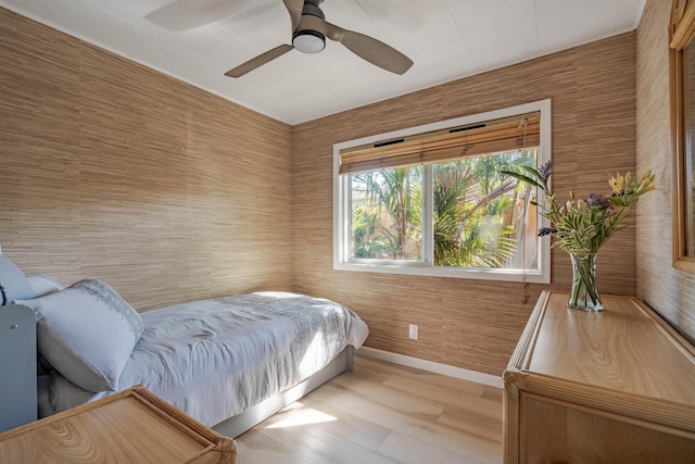 bedroom with ceiling fan and light hardwood / wood-style floors