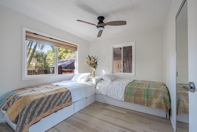 bedroom with ceiling fan and light hardwood / wood-style flooring