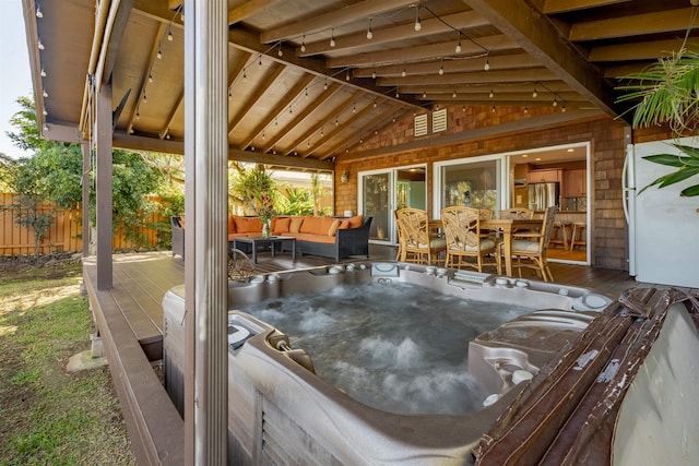 view of patio featuring a hot tub and a deck