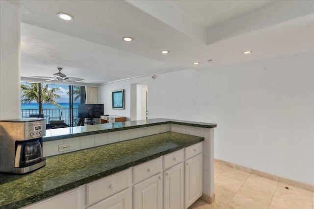 kitchen featuring white cabinets, ceiling fan, and light tile patterned flooring