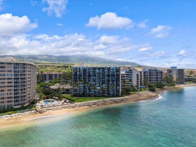 aerial view with a water and mountain view and a beach view