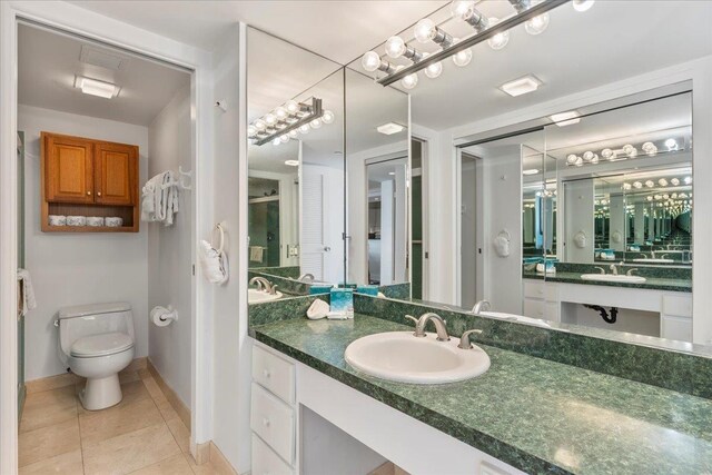 bathroom with tile patterned floors, vanity, and toilet