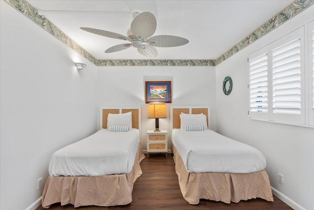 bedroom with ceiling fan and dark hardwood / wood-style flooring