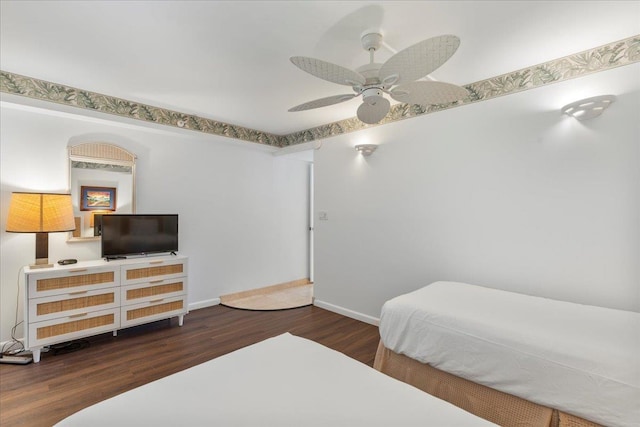 bedroom with ceiling fan and dark hardwood / wood-style floors