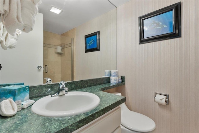 bathroom with vanity, toilet, and walk in shower