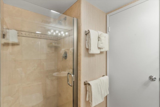 bathroom featuring a shower with door