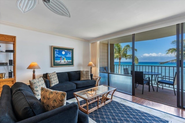 living room with a water view, crown molding, floor to ceiling windows, and wood-type flooring