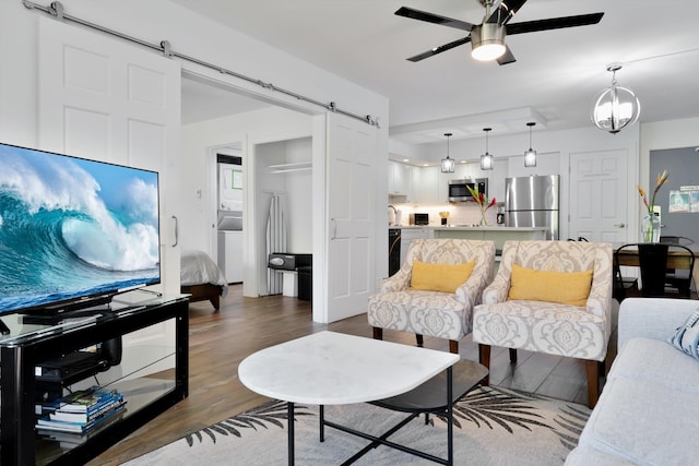 2575 S Kihei Rd Unit P-104, Kihei, HI 96753 - living area featuring a barn door, a ceiling fan, and dark wood-style floors