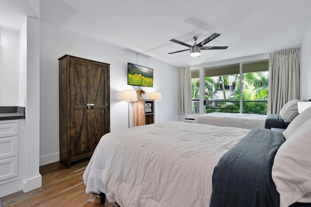 2575 S Kihei Rd Unit P-104, Kihei, HI 96753 - bedroom with wood finished floors, ceiling fan, and baseboards