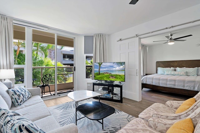 2575 S Kihei Rd Unit P-104, Kihei, HI 96753 - living area featuring a barn door, a ceiling fan, and wood finished floors