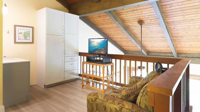 sitting room featuring vaulted ceiling with beams, light hardwood / wood-style floors, and wooden ceiling