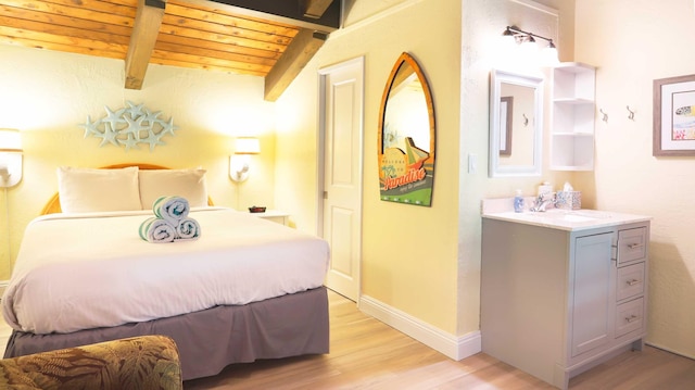 bedroom with lofted ceiling with beams, light hardwood / wood-style floors, wooden ceiling, and sink