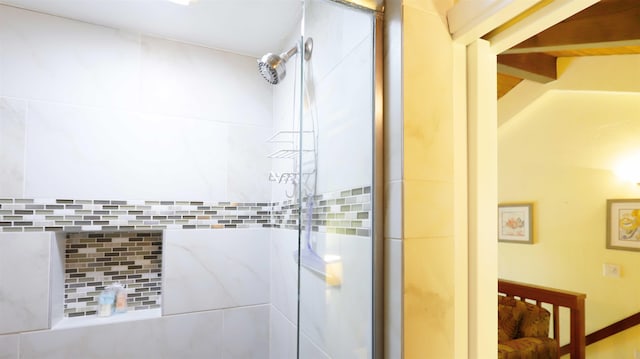 bathroom with tile walls and a tile shower