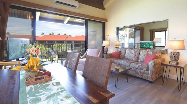 living room with hardwood / wood-style floors and a wall mounted AC