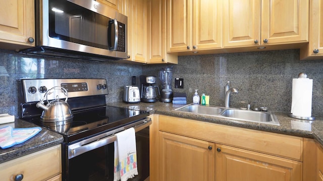 kitchen with decorative backsplash, appliances with stainless steel finishes, and sink