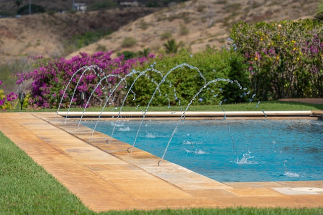 view of pool with pool water feature