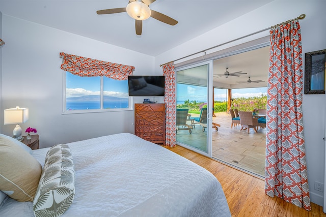 bedroom featuring multiple windows, access to outside, hardwood / wood-style flooring, and ceiling fan